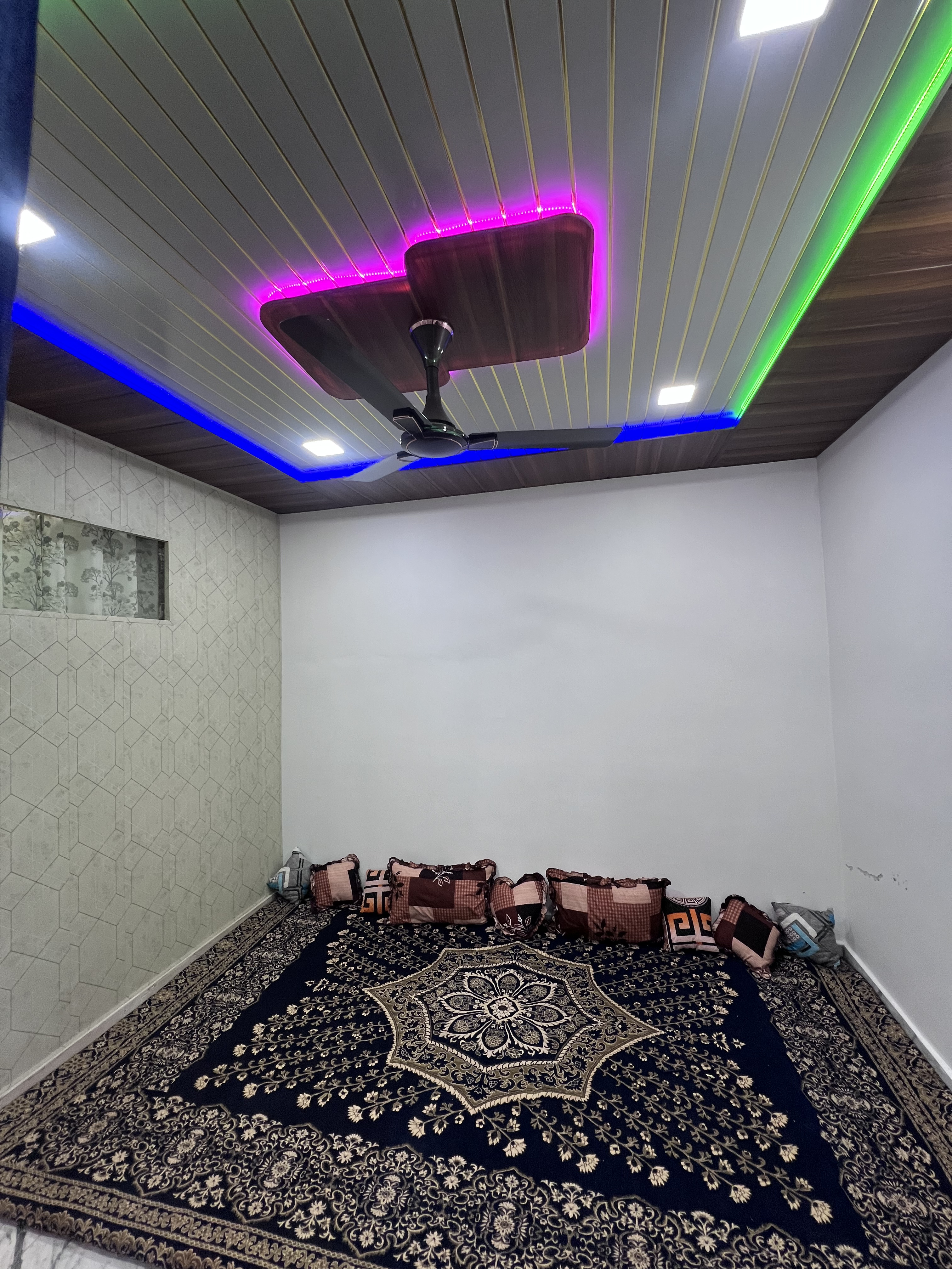 Sunlit bed next to a wide window